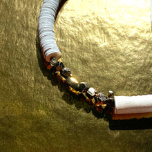 Load image into Gallery viewer, Our hand-stitched white leather choker with pyrite crystals embodies empowerment anchored by serenity. Pyrite deflects negative energy and promotes physical healing and mental strength. Complement any outfit with this choker that is soft, comfortable, and easy to wear. Shop now and feel empowered both inside and out.