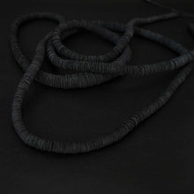 Load image into Gallery viewer, Elevate your style with our bold and modern extra-long necklace. Crafted with genuine leather disks ranging from 6-14mm and cotton waxed cord, it&#39;s a true statement piece that challenges the ideals of traditional accessories. Wear it as is or get creative by draping it around your waist or creating a crossed pattern. This disruptor of a necklace is sure to turn heads and start conversations. Shop now for a minimalistic yet eye-catching addition to your high-fashion wardrobe.