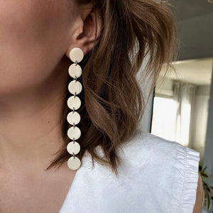 Elevate your style with a modern, asymmetric long mono earring. Lightweight and luxuriously soft, this flowy earring adds sophistication to any look, from elegant to casual. Embrace the beauty of imperfection and asymmetry for a confident, carefree expression. Comes with a single leather stud for a simple yet captivating design.