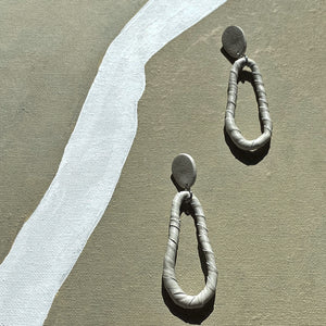 Discover the ultimate in versatility and style with our modern leather hoop earrings. Reshape them into circles or ovoids to reflect your mood of the moment, and enjoy their relaxed, carefree movement. Made from genuine leather and hypoallergenic stainless steel, these earrings are soft, lightweight, and add sophistication to any outfit. Express your personality with their distinct texture and shop now to experience the perfect combination of comfort and style.
