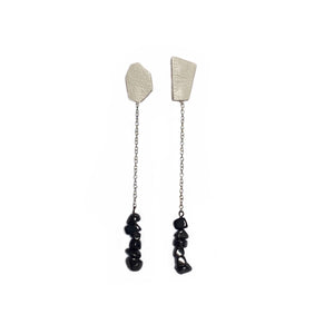 Elevate your style with our contemporary drop earrings. The asymmetrical form and contrasting elements add a modern edge, while luxurious textured leather and hematite provide sophistication and a touch of mystery. Hematite promotes calmness, strength, stability, and protection. With a carefree swing, these earrings allow you to stride tall and restore your equilibrium. Shop now for a statement piece that combines modern elegance with natural healing properties