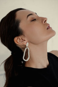 Discover the ultimate in versatility and style with our modern leather hoop earrings. Reshape them into circles or ovoids to reflect your mood of the moment, and enjoy their relaxed, carefree movement. Made from genuine leather and hypoallergenic stainless steel, these earrings are soft, lightweight, and add sophistication to any outfit. Express your personality with their distinct texture and shop now to experience the perfect combination of comfort and style.