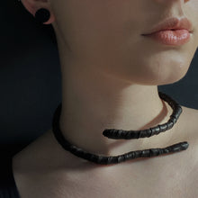 Load image into Gallery viewer, This genuine leather choker/bracelet hybrid lets you express your individuality and set your own standards of fashion. Wear it as a statement piece around your neck or wrist, or create customizable patterns for a unique look every time. Meticulously crafted with genuine leather wrapped around metal wire, this daring accessory is built to last. Be bold, be different, and let the Rebel Coil take your style to the next level.