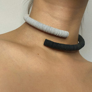 Made from individually punched genuine leather sequins and stainless steel memory wire, this choker is the softest, lightest, and most comfortable choker you will ever wear. It flexes easily to put on and adjusts to neck size, with absolutely no resistance against your neck, allowing you to forget its presence. With no clasp, this choker can be worn with the opening at the front.