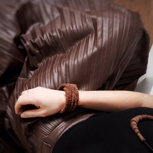 Make a statement with this helical leather cuff bracelet. Its bold simplicity and high texture are inspired by the natural world and the resilience it embodies. Crafted from individually punched genuine leather sequins, this cuff is soft, lightweight, and comfortable for all-day wear. The stainless steel memory wire allows for easy adjustment to fit any wrist size. Add a touch of nature-inspired elegance to your everyday look.