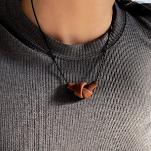 Elevate your style with a leather knot pendant necklace - a symbol of eternal connection and cherished bonds. With modern sophistication and impeccable hand craftsmanship, this necklace showcases the fine qualities of leather. Available in two lengths, it's functional art with a meaning, making it the perfect gift for yourself or a loved one. Choose the shorter length for a flattering collarbone accent or the longer length to wear over your heart.